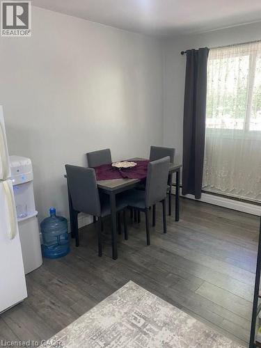 Dining room featuring wood finished floors and baseboard heating - 58 Hazelglen Drive, Kitchener, ON - Indoor