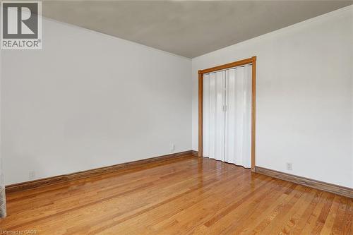Hardwood flooring throughout featuring natural wood baseboards and door trim - 14 Niagara Street, Hamilton, ON 