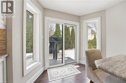 Doorway to outside featuring baseboards and wood finished floors - 28 Deerview Avenue, Ancaster, ON 