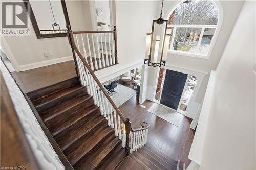 Entryway with dark wood-type flooring, a high ceiling, and plenty of natural light - 28 Deerview Avenue, Ancaster, ON 