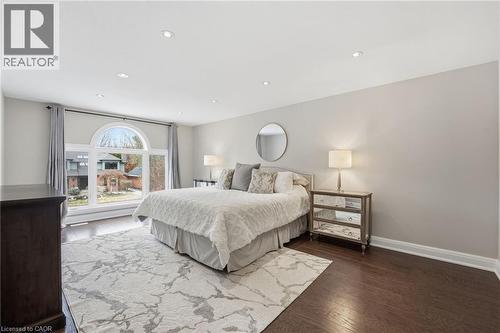 Bedroom with recessed lighting and dark wood-style flooring - 28 Deerview Avenue, Ancaster, ON 