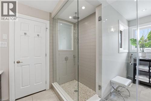 Full bathroom featuring vanity, a shower stall, light tile patterned floors, and recessed lighting - 28 Deerview Avenue, Ancaster, ON 