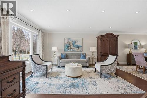Living area featuring crown molding, dark wood finished floors, and recessed lighting - 28 Deerview Avenue, Ancaster, ON 