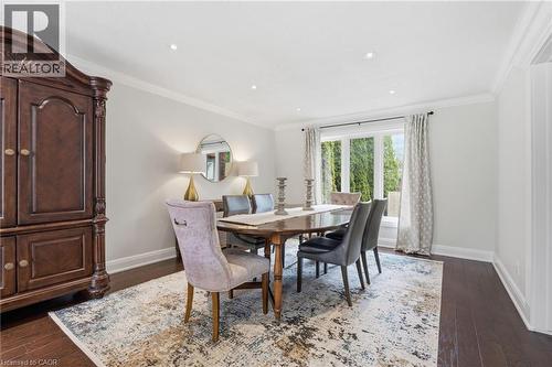 Dining room featuring dark wood-style floors, crown molding, and recessed lighting - 28 Deerview Avenue, Ancaster, ON 