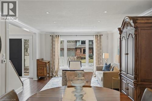 Dining space with ornamental molding and dark wood finished floors - 28 Deerview Avenue, Ancaster, ON 
