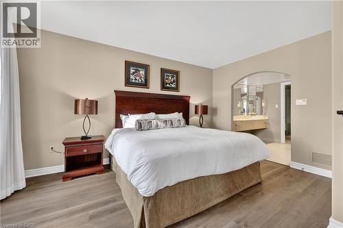 Bedroom with light wood-style floors and ensuite bathroom - 90 Highland Drive Unit# 2014/15, Simcoe, ON 