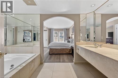 Ensuite bathroom with vanity, a jetted tub, light tile patterned floors, and recessed lighting - 90 Highland Drive Unit# 2014/15, Simcoe, ON 