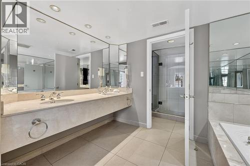 Full bathroom featuring double vanity, a garden tub, a stall shower, light tile patterned floors, and recessed lighting - 90 Highland Drive Unit# 2014/15, Simcoe, ON 
