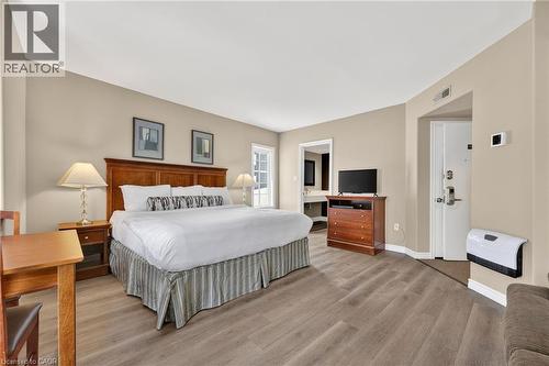 Bedroom featuring wood finished floors and ensuite bathroom - 90 Highland Drive Unit# 2014/15, Simcoe, ON 