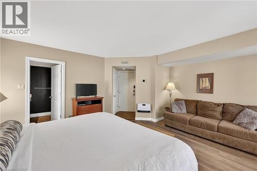 Bedroom featuring dark wood-style floors and baseboards - 90 Highland Drive Unit# 2014/15, Simcoe, ON 