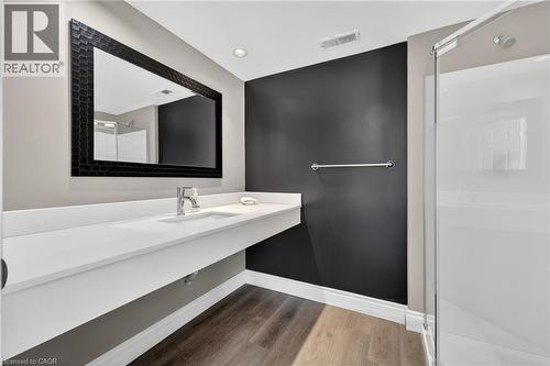 Bathroom with vanity, light wood-style flooring, and a shower stall - 90 Highland Drive Unit# 2014/15, Simcoe, ON 