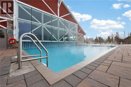 Community pool featuring a patio area and glass enclosure - 90 Highland Drive Unit# 2014/15, Simcoe, ON 