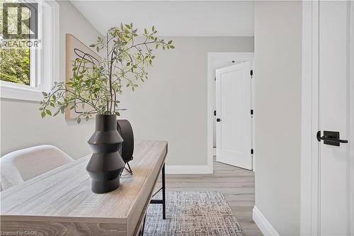 Bright interior space featuring light wood-finish flooring, white trim, and a window with natural light - 71 Blucher Street Unit# G, Kitchener, ON 