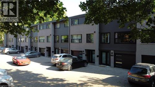Modern townhome exteriors featuring light gray brick and dark gray horizontal siding - 71 Blucher Street Unit# G, Kitchener, ON 