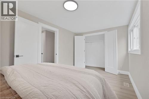 Light gray walls with white trim, wood-finish flooring, and a flush-mount ceiling light fixture - 71 Blucher Street Unit# G, Kitchener, ON 