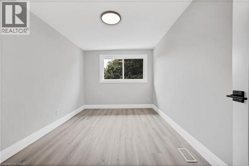 Light gray walls complemented by wood-finish flooring - 71 Blucher Street Unit# G, Kitchener, ON 