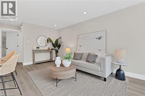 Open-concept living area featuring light wood-finish flooring, recessed lighting, and neutral wall tones - 71 Blucher Street Unit# G, Kitchener, ON 