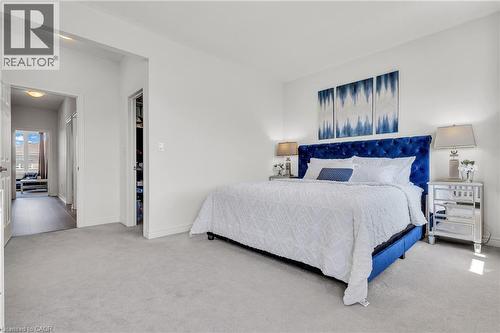 Spacious room featuring light gray carpeting, crisp white walls, and a recessed closet - 101 Westfield Crescent, Waterdown, ON 