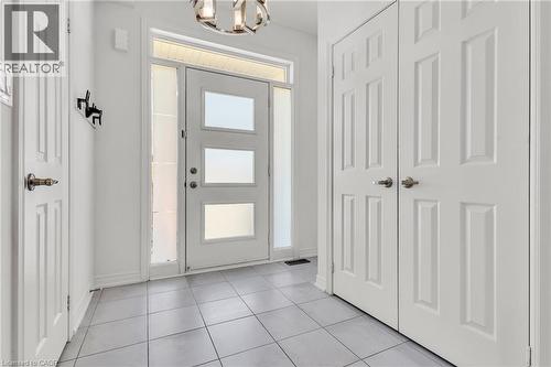 Foyer- Entryway featuring a contemporary front door with three frosted glass panels, transom window, and two sidelights - 101 Westfield Crescent, Waterdown, ON 