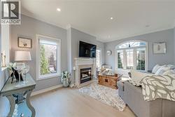 Living area featuring light wood-finish flooring, recessed lighting, and crown molding - 
