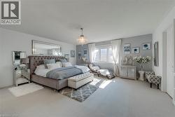 Spacious room featuring light-toned carpet flooring and neutral wall tones - 