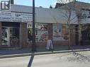 Commercial storefront featuring two distinct units under a corrugated metal awning - 71 Ross Street Unit# 2, St. Thomas, ON 