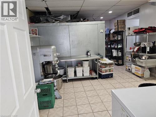Commercial kitchen space featuring a large walk-in cooler, stainless steel work tables, and tiled flooring - 71 Ross Street Unit# 2, St. Thomas, ON 