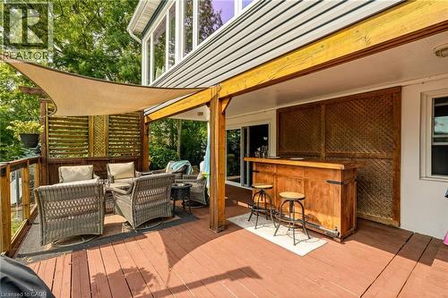 Expansive outdoor deck featuring wood flooring, a built-in wooden bar, and a slatted privacy screen - 5258 Cedar Springs Road, Burlington, ON - Outdoor With Deck Patio Veranda With Exterior