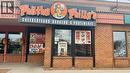 Commercial storefront featuring a prominent illuminated sign, brick facade, and multiple display windows - 2405 Fairview Street, Burlington, ON 