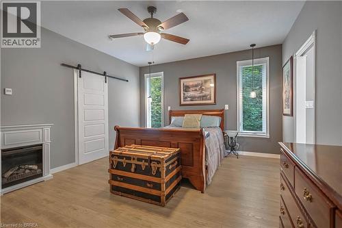 Primary Bedroom with Walk-In Closet + Spa Like Ensuite - 156 St Johns Road W, Simcoe, ON - Indoor Photo Showing Bedroom With Fireplace