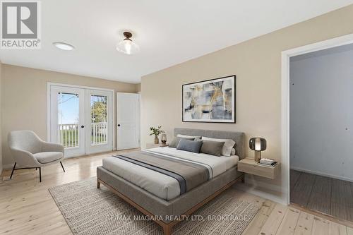 Virtually staged master bed with doors to deck - 696 Lakeshore Road, Fort Erie (Lakeshore), ON - Indoor Photo Showing Bedroom