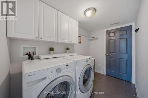 Lower Level Laundry w/ cabinetry & sink - 599 Foxlight Circle, Ottawa, ON - Indoor Photo Showing Laundry Room