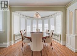 Dining area featuring a curved bay window with individual window blinds - 