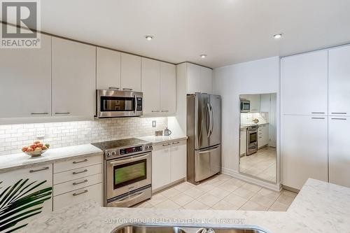 Kitchen with Stainless Appliances - 404 - 80 Palace Pier Court, Toronto, ON - Indoor Photo Showing Kitchen With Upgraded Kitchen