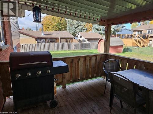 Covered outdoor deck featuring a wood-plank floor and slatted wood railing - 66 Summit Avenue, Kitchener, ON - Outdoor With Deck Patio Veranda With Exterior