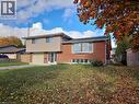 Brick and siding exterior featuring an attached garage with a light-colored door - 66 Summit Avenue, Kitchener, ON  - Outdoor 