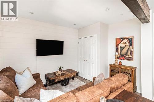 Accent wall featuring horizontal shiplap paneling and a wall-mounted display - 134 Erie Avenue, Hamilton, ON 