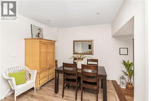 Dining area featuring wood-finish flooring, recessed lighting, and a framed wall mirror - 134 Erie Avenue, Hamilton, ON 
