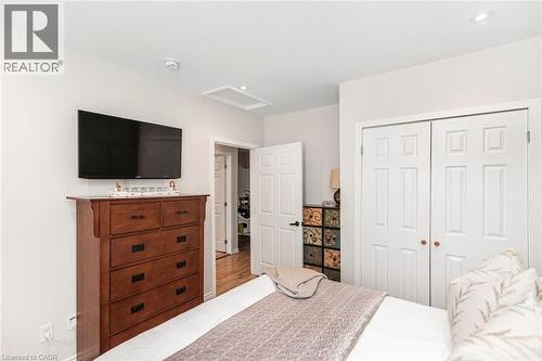 Bedroom featuring bright white walls, recessed lighting, and a bi-fold closet with panel doors - 134 Erie Avenue, Hamilton, ON 