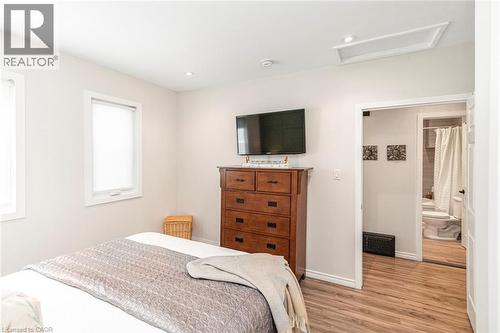 Room featuring wood-finish flooring, recessed lighting, and white trim - 134 Erie Avenue, Hamilton, ON 