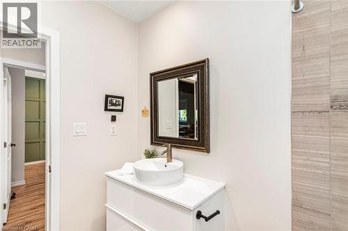 Bathroom featuring a vessel sink atop a white vanity with brushed nickel hardware - 134 Erie Avenue, Hamilton, ON 