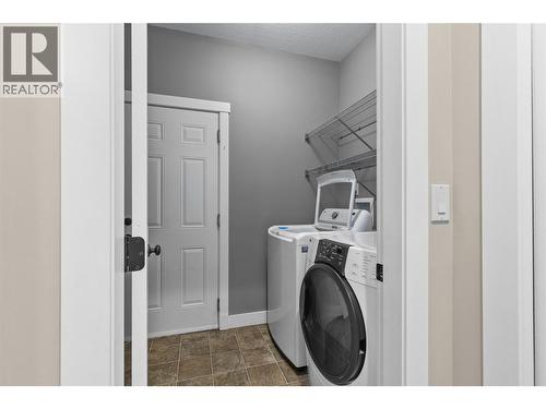 Laundry room that leads in the garage - 479 Middleton Way, Coldstream, BC - Indoor Photo Showing Laundry Room