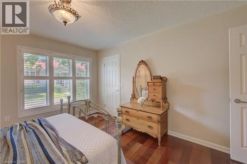 Interior space featuring wood-finish flooring, light-colored walls, and a ceiling light fixture - 137 Wesley Crescent, Waterloo, ON 