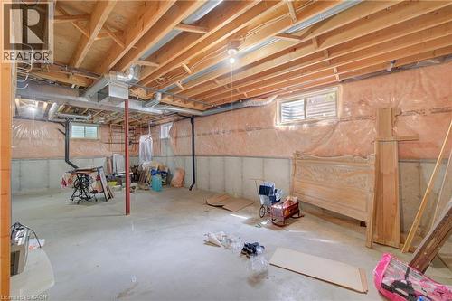 Spacious unfinished basement offering exposed wood joists and concrete flooring - 137 Wesley Crescent, Waterloo, ON 