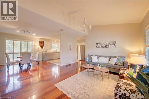 Open-concept living area with lustrous wood-finish flooring - 137 Wesley Crescent, Waterloo, ON 