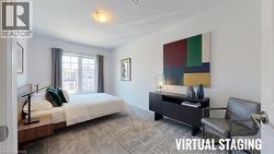 Spacious room featuring a large window with grey drapes, light-toned walls, and a textured area rug - 