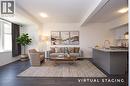 Open-concept living space featuring dark wood-finish flooring, white walls, and recessed lighting - 10 Birmingham Drive Unit# 129, Cambridge, ON 
