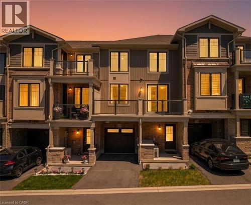 Modern townhome exterior featuring brick and siding finishes - 10 Birmingham Drive Unit# 129, Cambridge, ON - Outdoor With Balcony With Facade