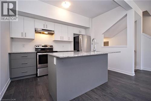 Modern kitchen featuring white upper cabinetry and grey base cabinetry - 10 Birmingham Drive Unit# 129, Cambridge, ON - Indoor Photo Showing Kitchen With Stainless Steel Kitchen With Upgraded Kitchen