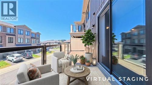 Outdoor balcony featuring glass panel railings, wood-look flooring, and a sliding glass door - 10 Birmingham Drive Unit# 129, Cambridge, ON - Outdoor With Balcony